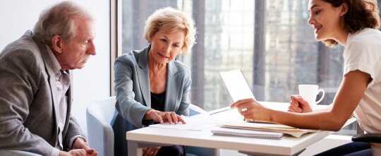 Senior Couple Meeting with Female Financial Advisor in Office