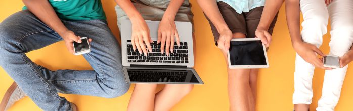 teenagers with different devices against coloured background